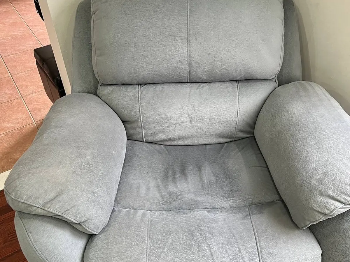 A fabric recliner armchair