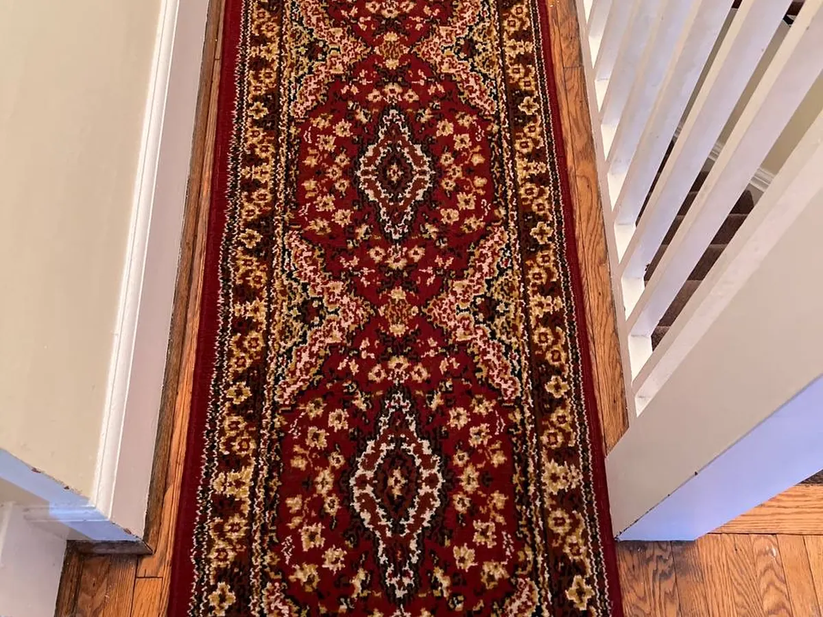 A patterned hallway runner on stairs